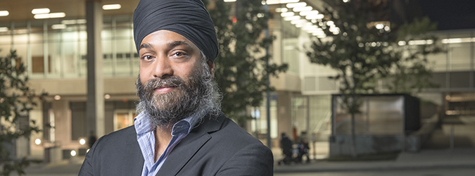 man wearing a turban standing outside a hospital